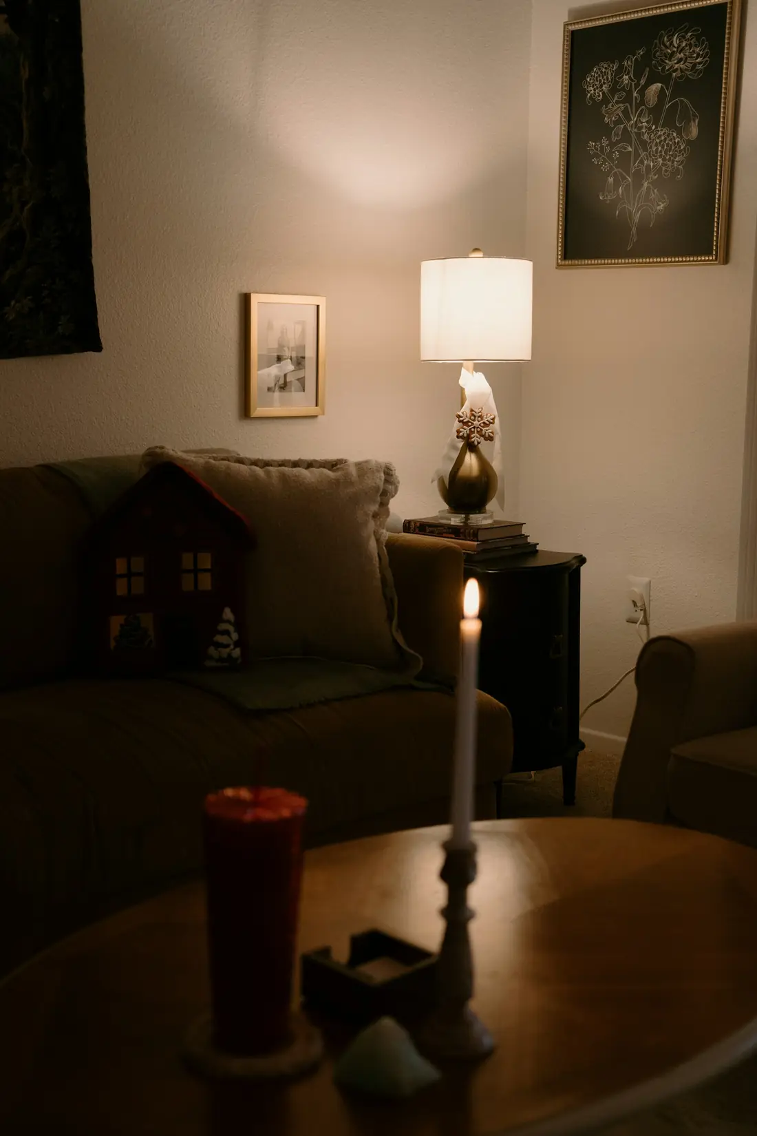 A warm living room lit by a lamp